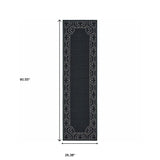 2' X 8' Black and Ivory Stain Resistant Indoor Outdoor Area Rug