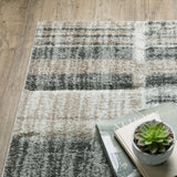 8' X 11' Ivory Beige Grey Brown Pale Blue And Charcoal Geometric Power Loom Stain Resistant Area Rug