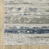 10' X 13' Grey Blue Ivory Brown And Navy Abstract Power Loom Stain Resistant Area Rug