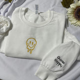 Smiley Face with Choose Happy embroidered on the cuff of the sleeve embroidered crewneck